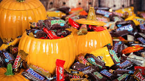 chocolate candy bars overflowing out of pumpkin buckets 